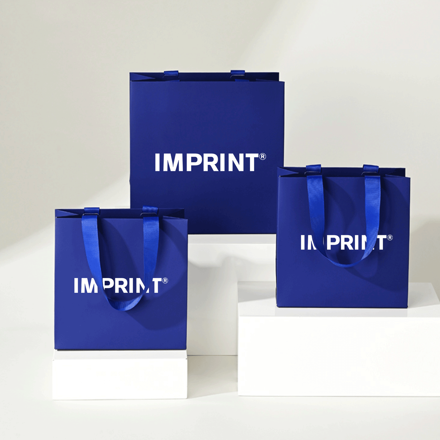 Custom Deep Blue Laminated Paper Bag with Grosgrain Handles – IMPRINT®